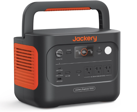 A Jackery Explorer 1000 portable power station featuring multiple output ports, an LCD screen, and a carrying handle for outdoor use.