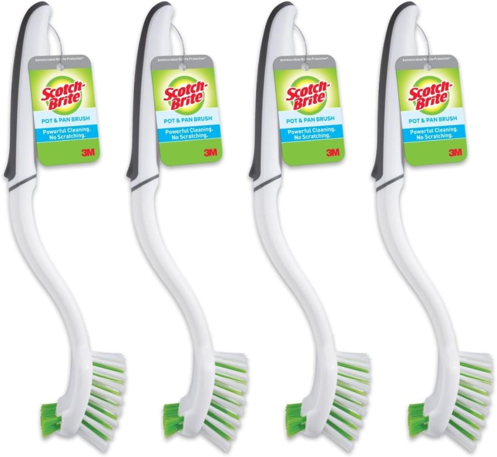 Four Scotch-Brite pot and pan brushes with green bristles, designed for powerful cleaning without scratching.
