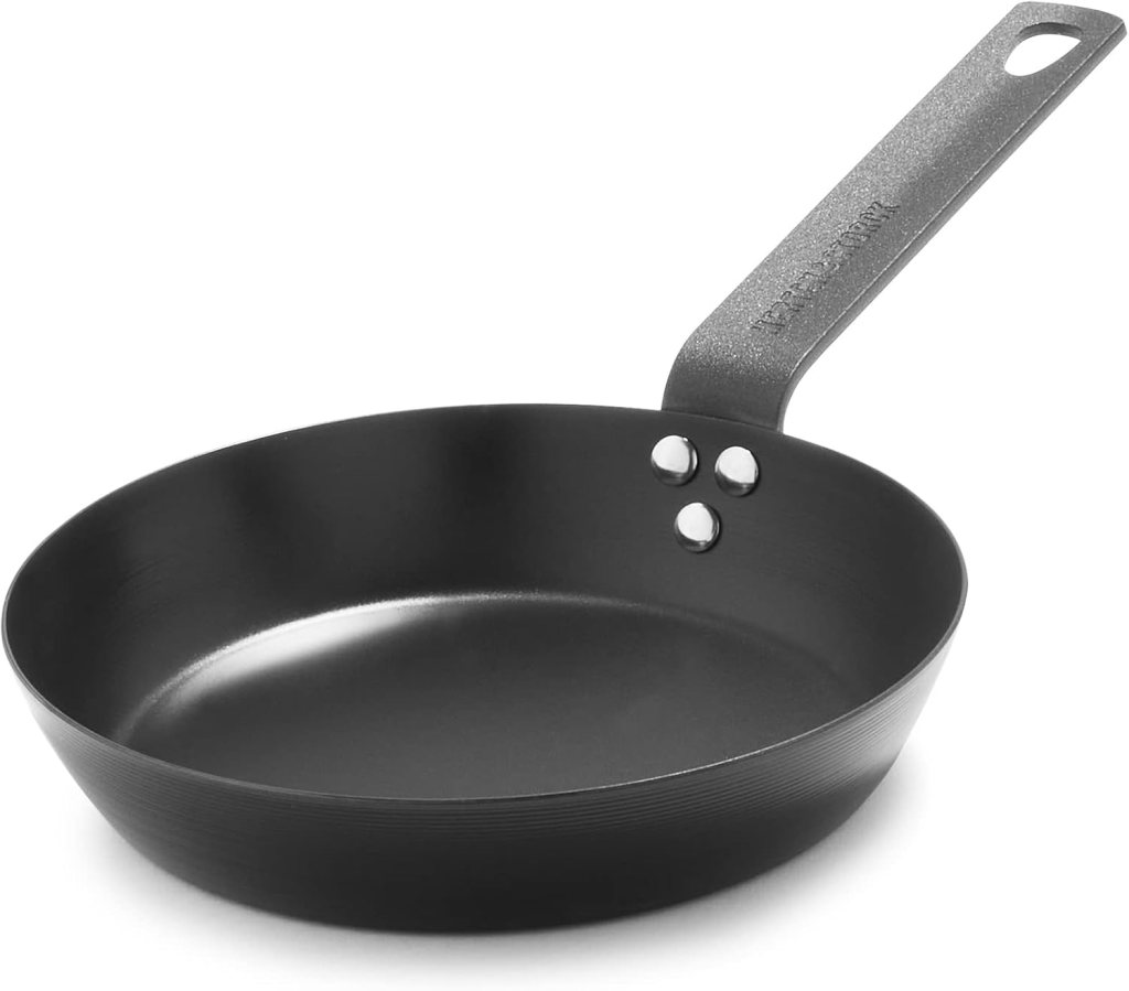 Pre-seasoned carbon steel 8-inch frying pan skillet with a flat base and a sturdy handle.