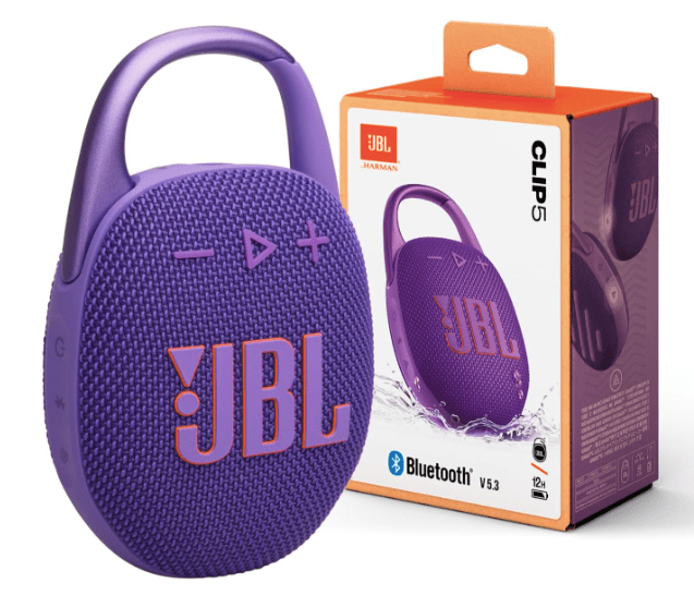 A purple JBL Clip 5 Bluetooth speaker with control buttons and an attached carabiner, displayed next to its packaging featuring product details.