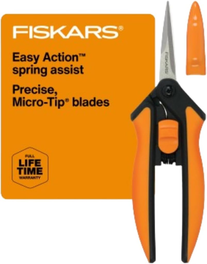 Fiskars 6" pruning scissors with orange ergonomic handles and stainless steel blades, displayed alongside packaging featuring product details.