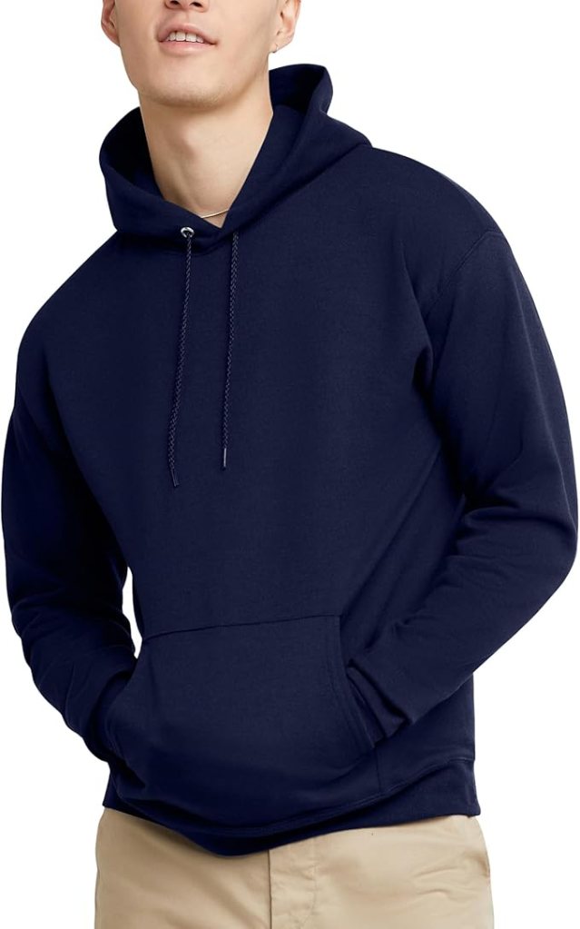 A young man wearing a navy blue Hanes EcoSmart fleece hoodie sweatshirt with a front pocket and drawstring hood.