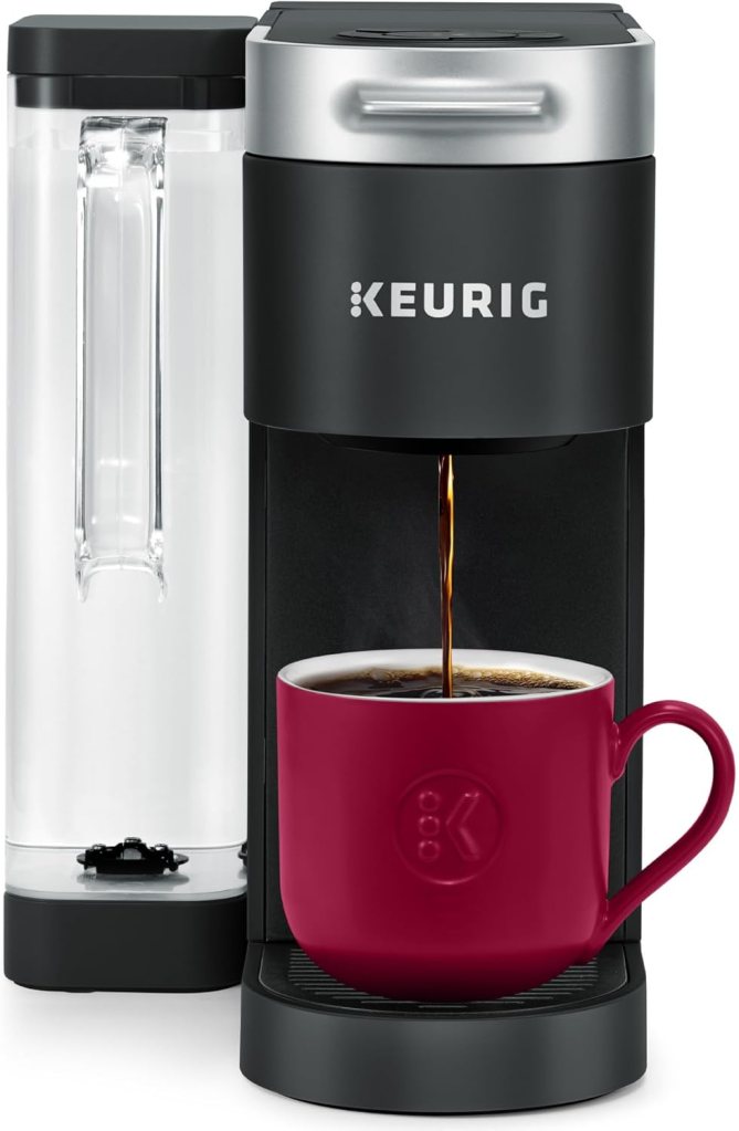 A Keurig K-Supreme Single Serve K-Cup Pod Coffee Maker with a dual-position removable reservoir, pouring coffee into a red mug.