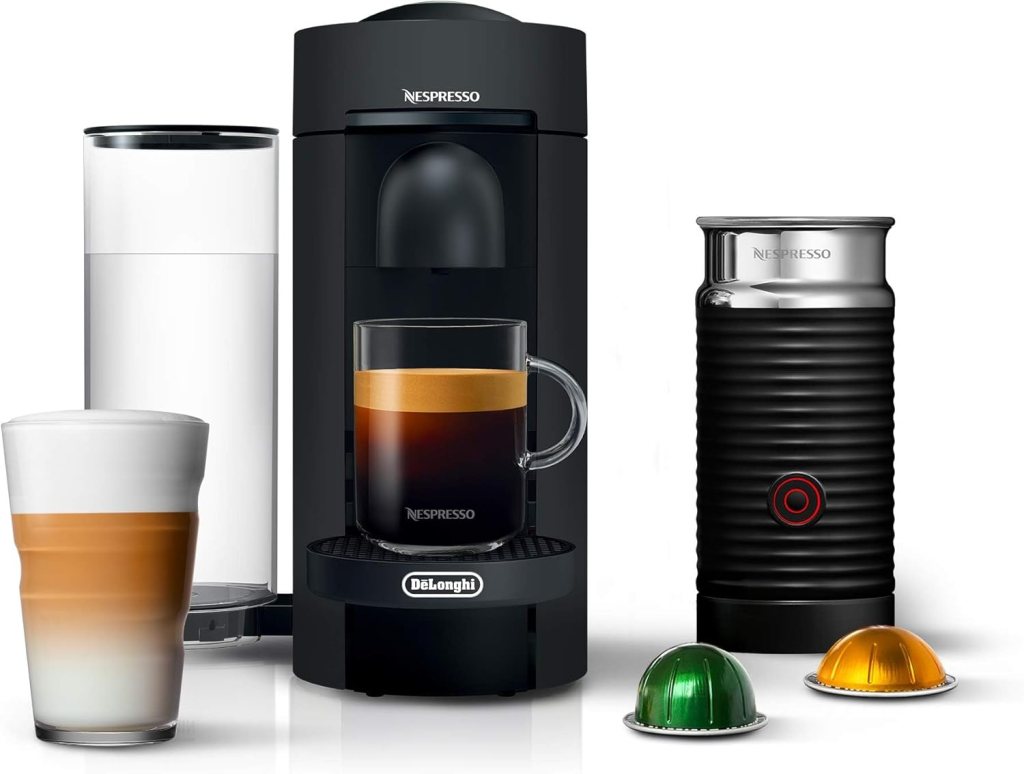 A Nespresso Vertuo Plus Deluxe Coffee and Espresso Maker in matte black is displayed alongside an Aeroccino milk frother, two coffee cups, and coffee pods.