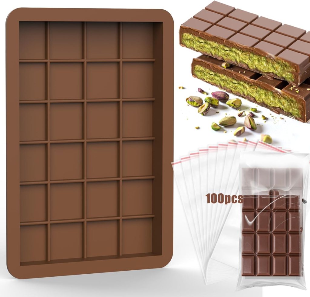 A silicone chocolate bar mold with deep compartments, featuring a filled chocolate bar with pistachio filling, surrounded by 100 plastic storage bags.