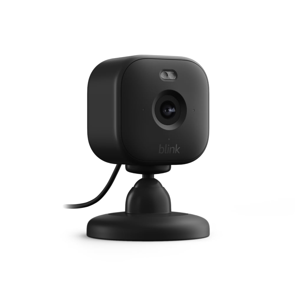 Close-up view of a Blink Mini home security camera in black, featuring a circular base and a lens on the front.
