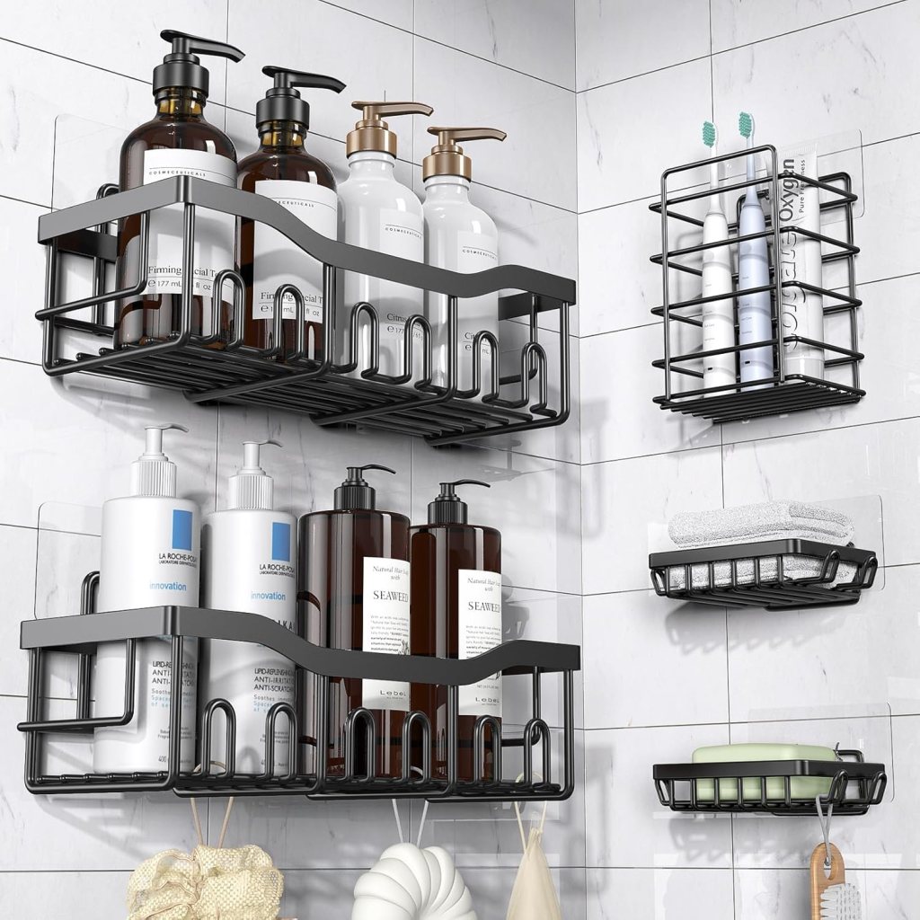 Three black wire shower caddies on a tiled bathroom wall, holding various bottles of shampoo, conditioner, and body wash, along with toothbrushes and towels.